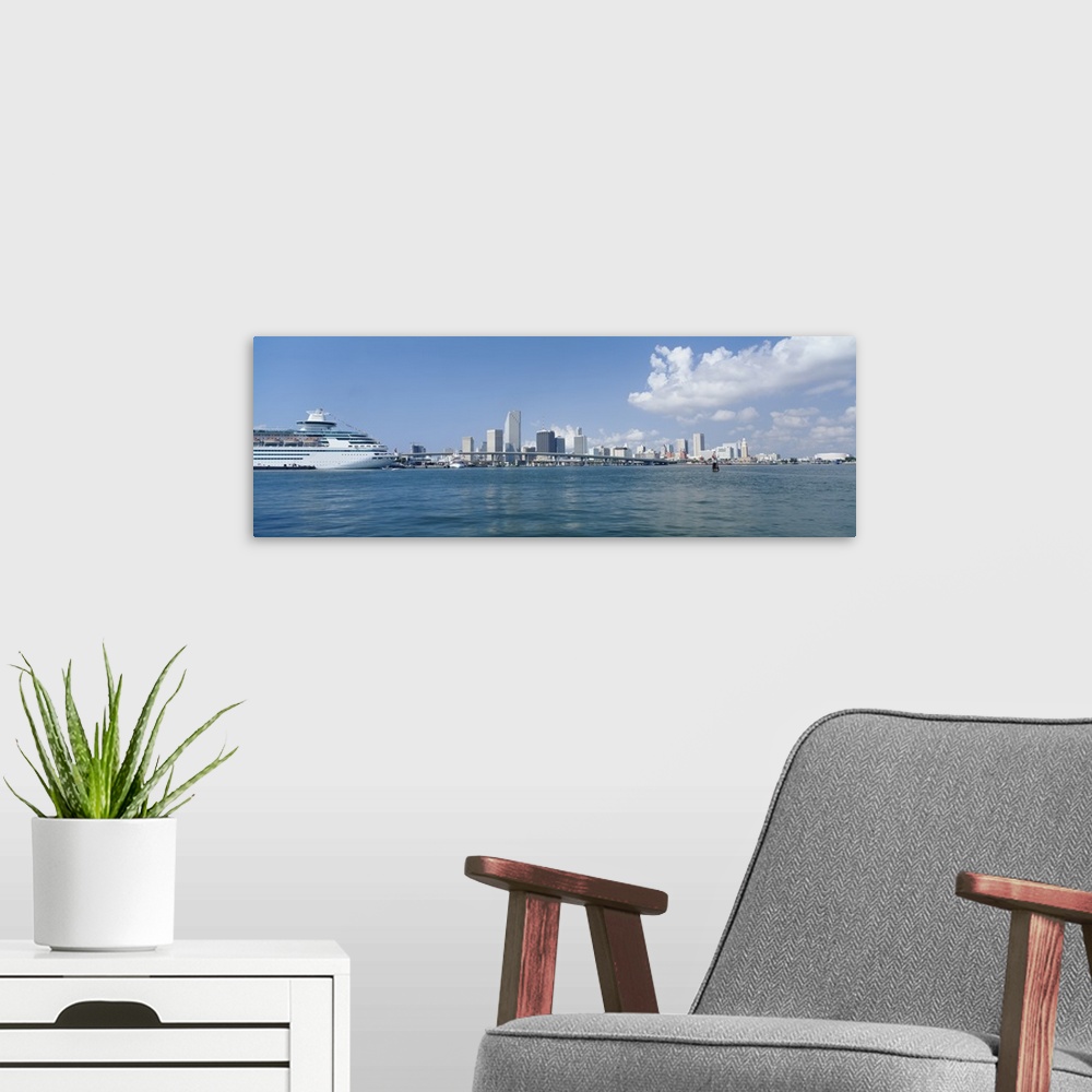 A modern room featuring Panoramic view of Miami Florida's Biscayne Bay waterfront with ship on the water.