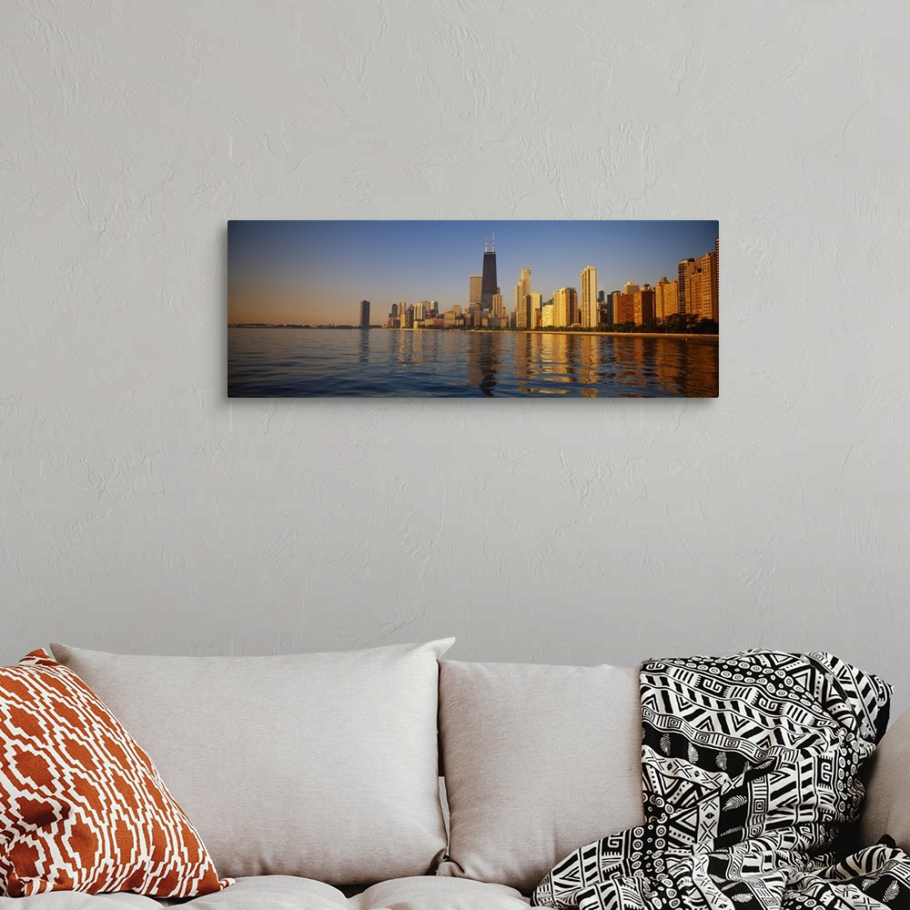 A bohemian room featuring Long horizontal photo of the skyline of Chicago meeting the water front at sunset printed onto ca...