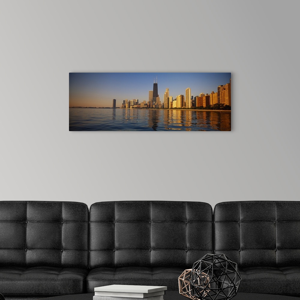 A modern room featuring Long horizontal photo of the skyline of Chicago meeting the water front at sunset printed onto ca...