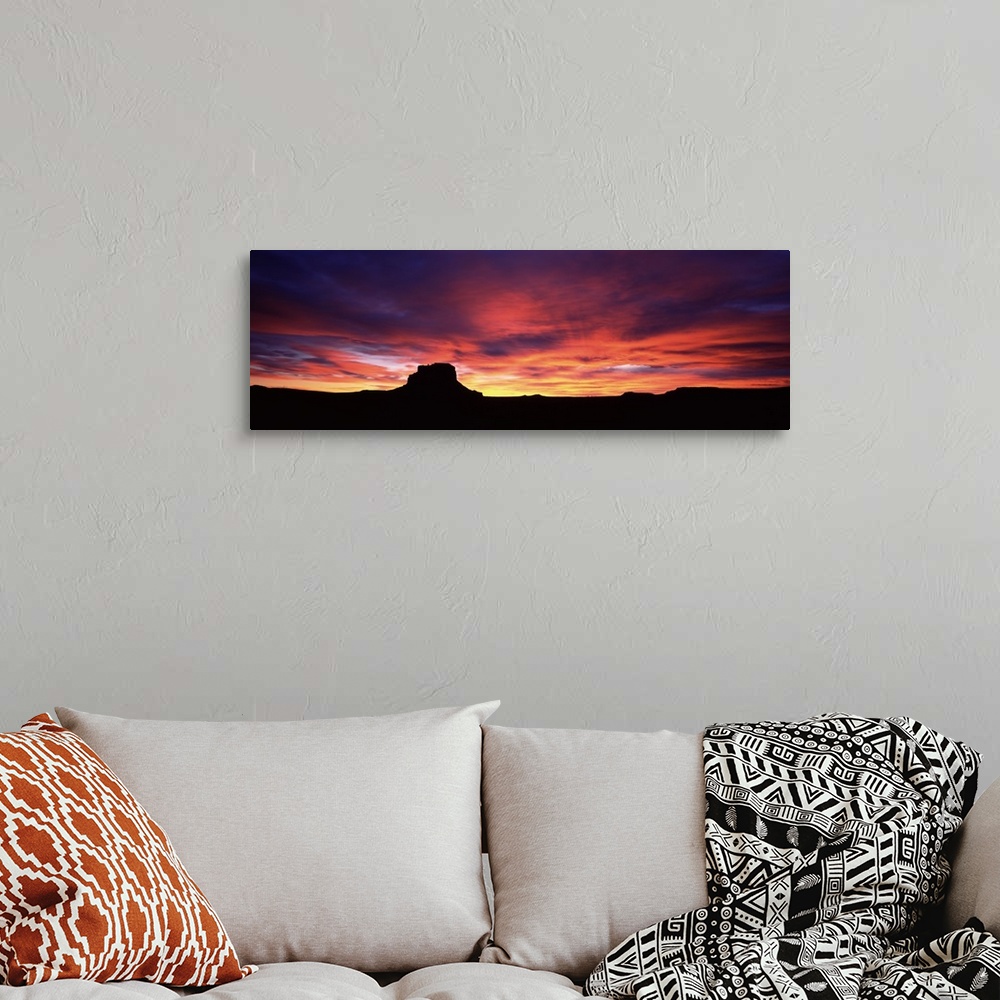 A bohemian room featuring Silhouette of the buttes as the sun sets over the Chaco Culture National Historic Park in New Mex...