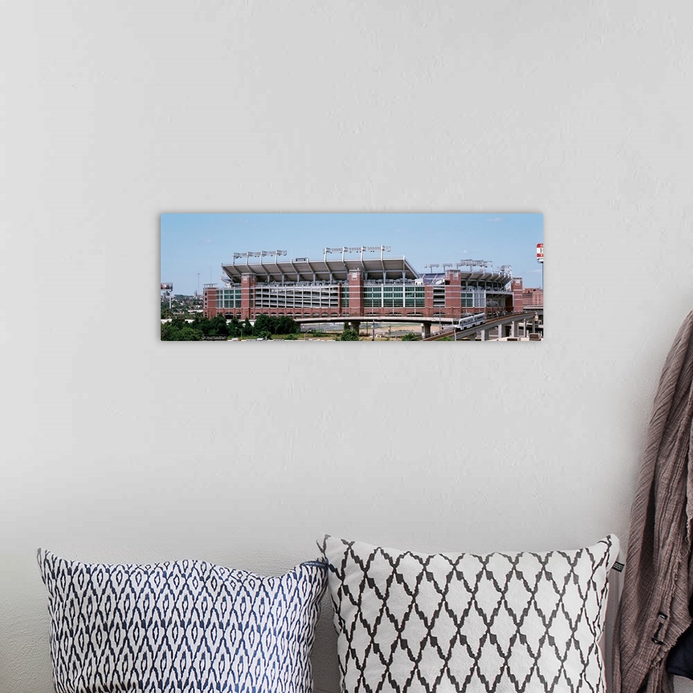 A bohemian room featuring Giant, horizontal photograph taken from a hanging cable car of the outside of M & T Back Stadium ...