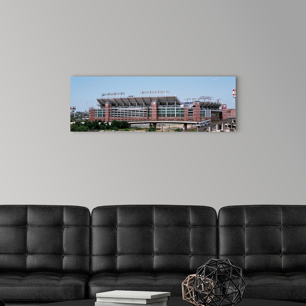 A modern room featuring Giant, horizontal photograph taken from a hanging cable car of the outside of M & T Back Stadium ...