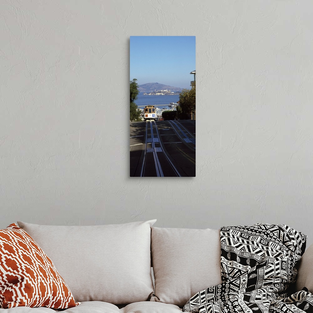 A bohemian room featuring Vertical panoramic photograph of street trolley moving toward the horizon with harbor, waterfront...