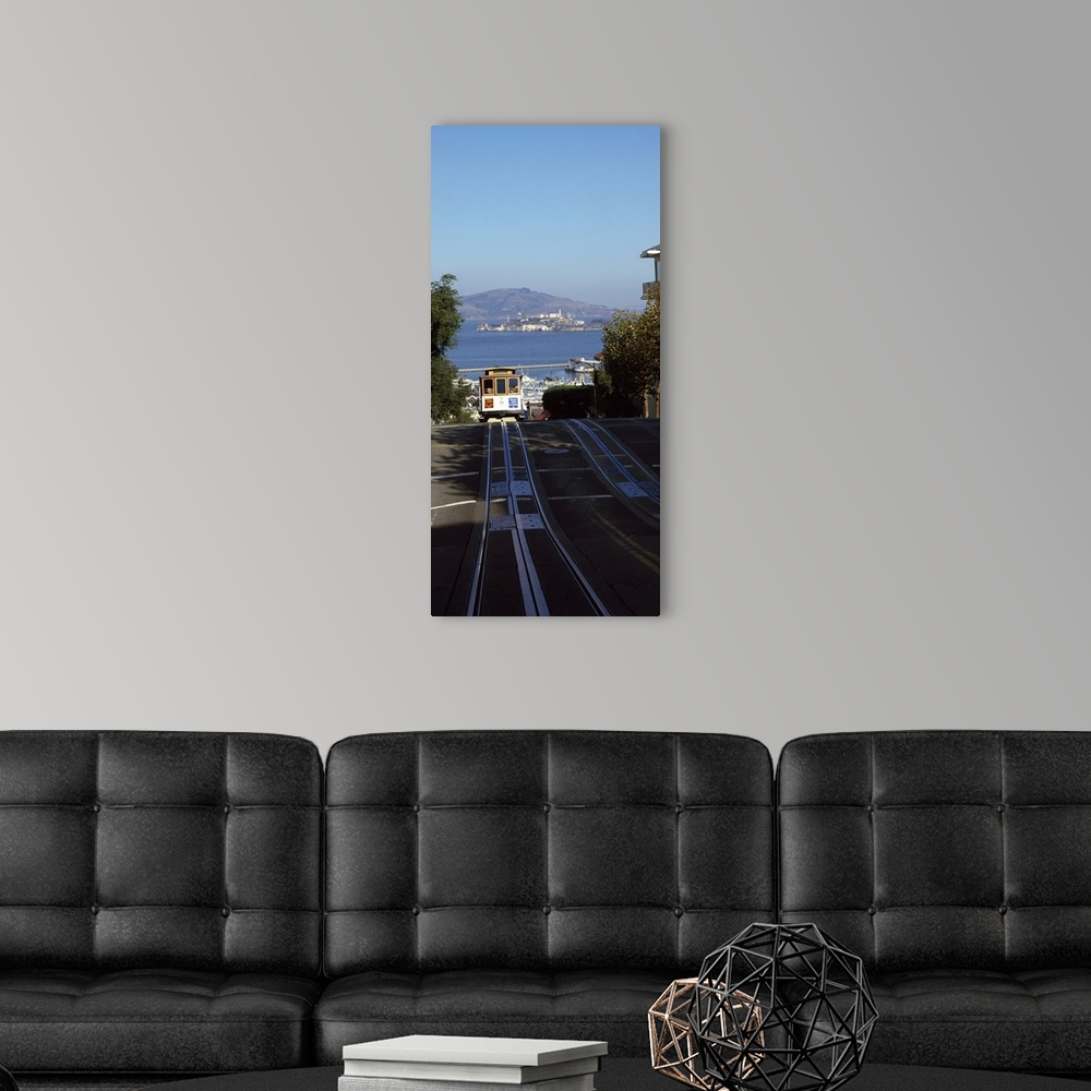 A modern room featuring Vertical panoramic photograph of street trolley moving toward the horizon with harbor, waterfront...