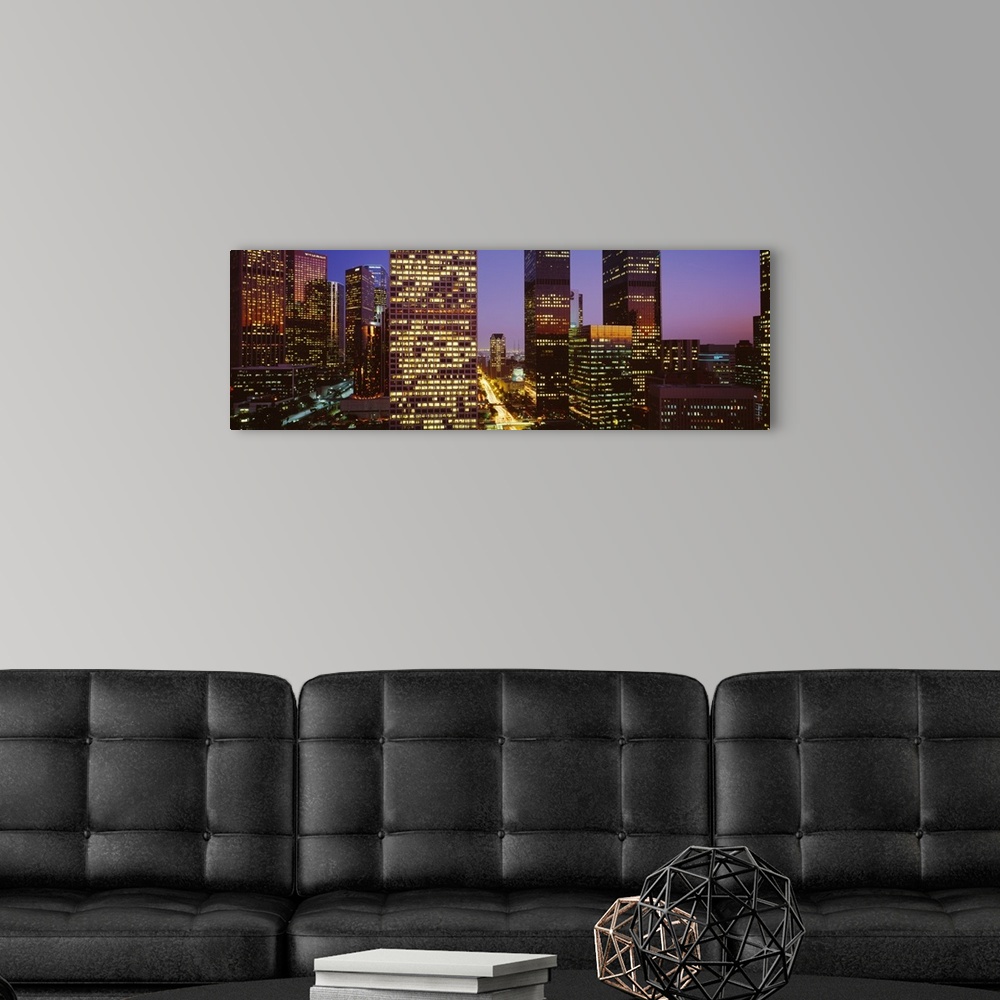 A modern room featuring Panoramic, close up photograph of lit skyscrapers at night, in Los Angeles, California, a vivid s...