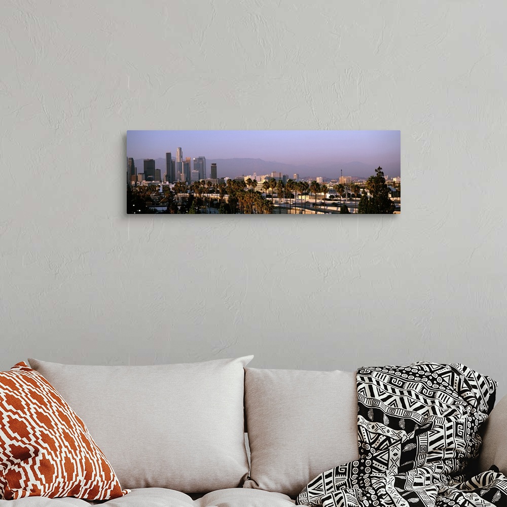 A bohemian room featuring Panoramic photograph of cityscape under fog with mountain silhouette in the distance.