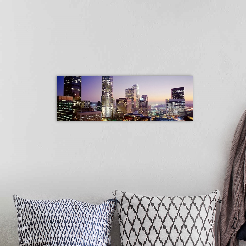 A bohemian room featuring Wide angle photograph on a big canvas of the brightly lit skyline of Los Angeles, California, at ...