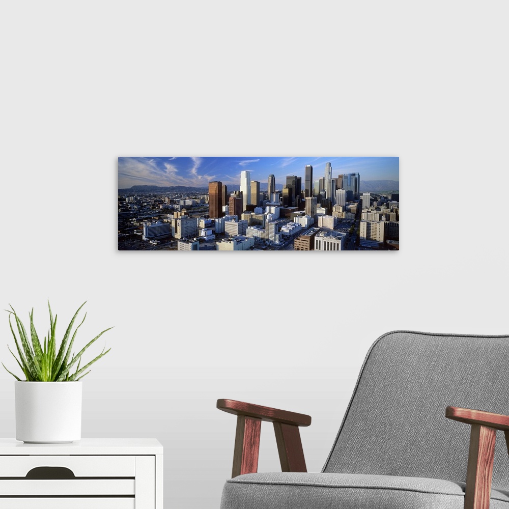 A modern room featuring An aerial panoramic photograph taken of downtown Los Angeles as the sun sets and hits the sides o...