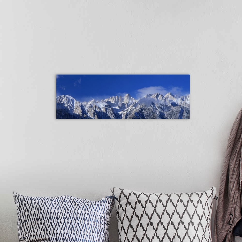 A bohemian room featuring Panoramic photograph of snow covered Mount Whitney beneath a vibrant blue sky in California.