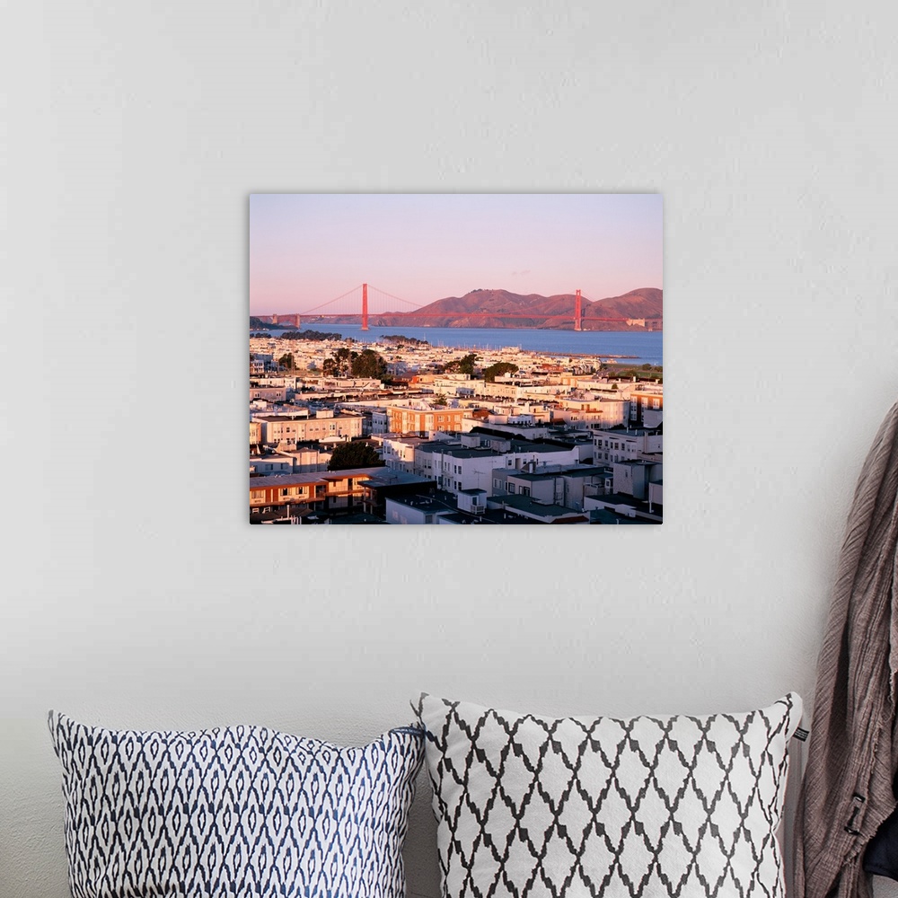 A bohemian room featuring This decorative wall art is a photograph of houses around the bay and the Golden Gate Bridge in t...