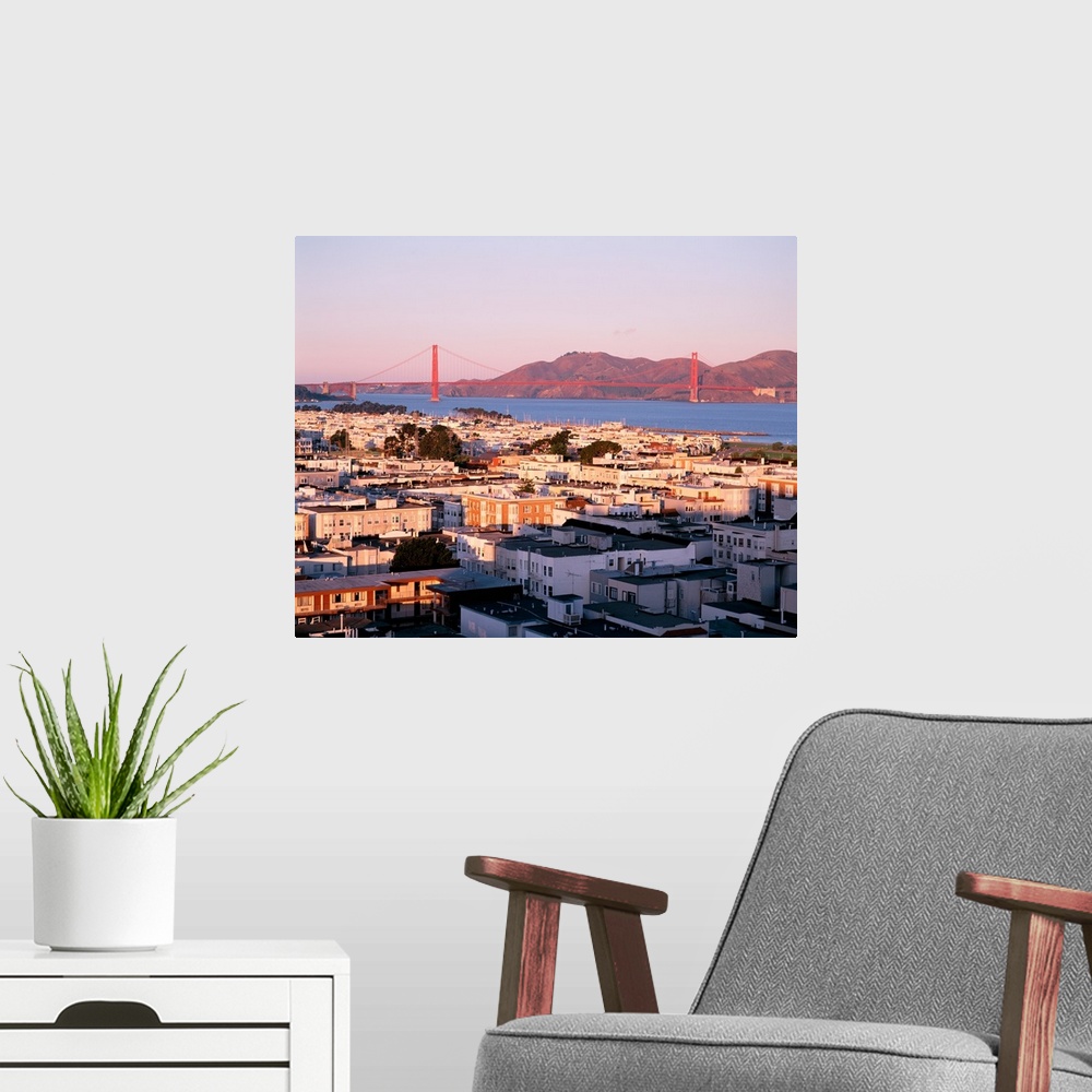 A modern room featuring This decorative wall art is a photograph of houses around the bay and the Golden Gate Bridge in t...