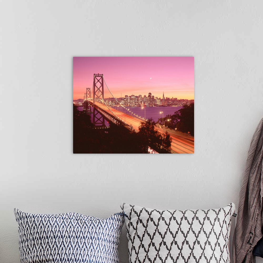 A bohemian room featuring Big photograph displays a large overpass near the coast of the Western United States brightly shi...
