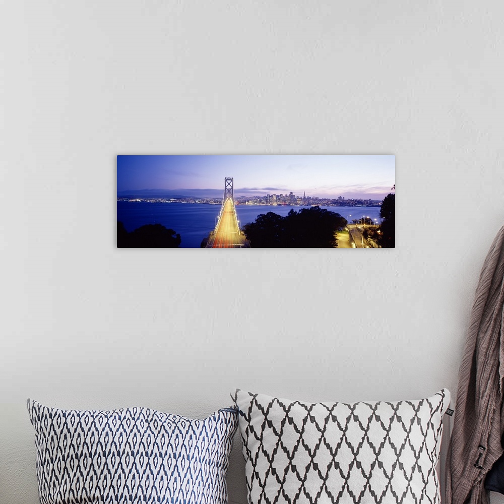 A bohemian room featuring San Francisco Bridge light up at night over the Bay with views of downtown skyline.