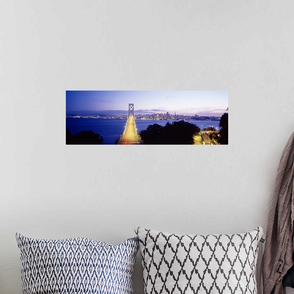 A bohemian room featuring San Francisco Bridge light up at night over the Bay with views of downtown skyline.