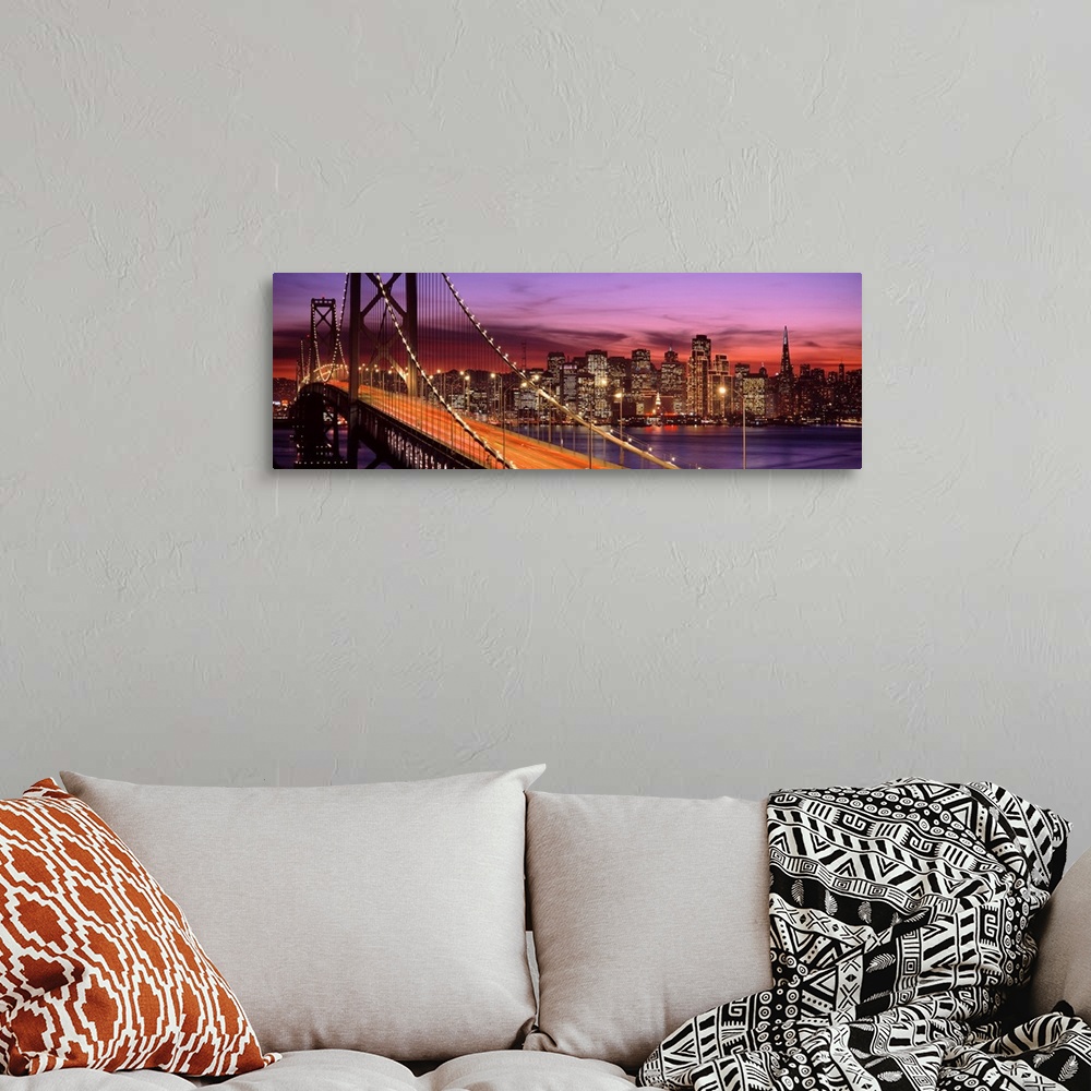 A bohemian room featuring Panoramic photograph of the San Francisco Bay Bridge and the brightly lit city skyline at dusk.