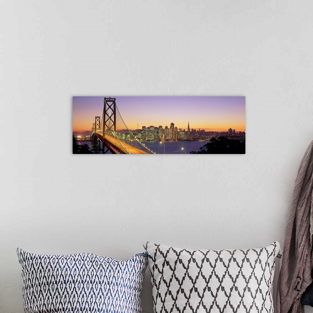 A bohemian room featuring Twilight and the Golden Gate Bridge with the San Francisco Skyline with a purple and gold sky.
