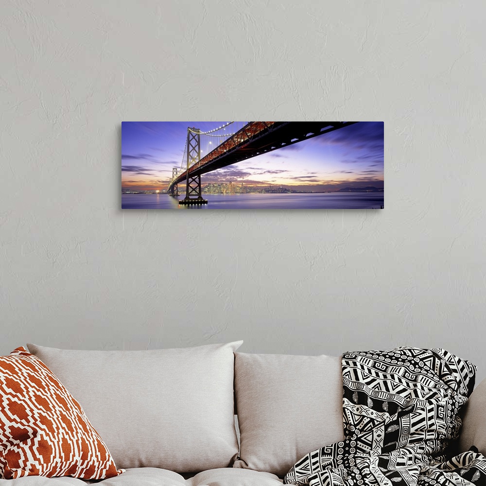A bohemian room featuring Panoramic photograph of lit up overpass at sunset with city skyline in the distance.