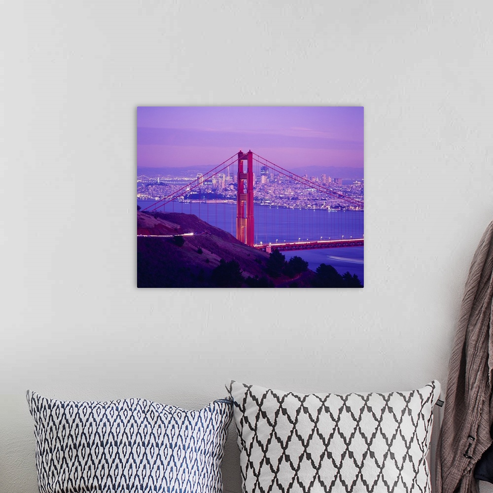 A bohemian room featuring Giant photograph focuses on one of the supports for a famous overpass that spans a large bay with...