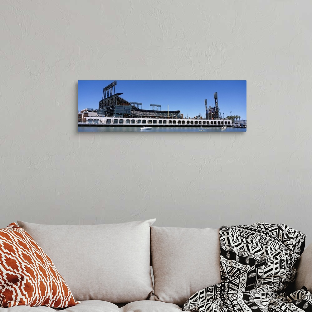 A bohemian room featuring The San Francisco Giants baseball stadium is photographed from the waterfront view.