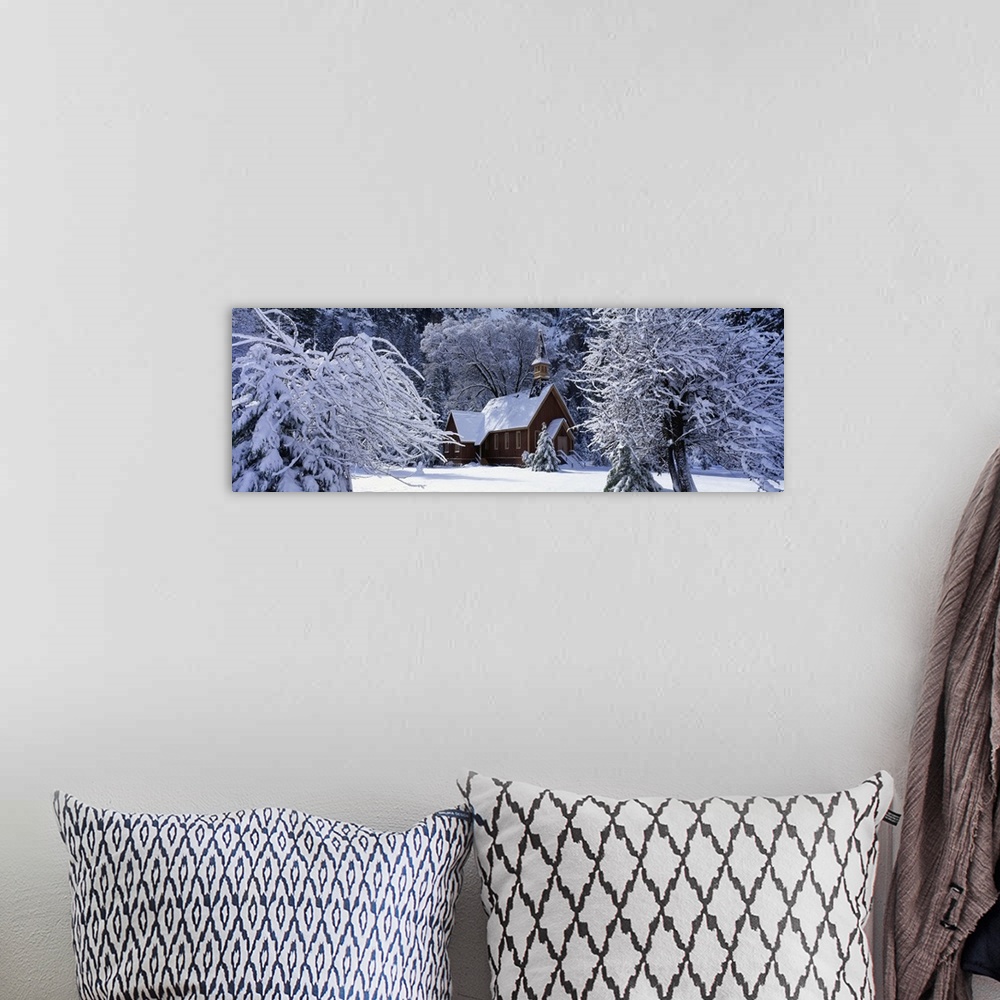 A bohemian room featuring Panoramic photo of a church in winter covered in snow at Yosemite National Park in California.