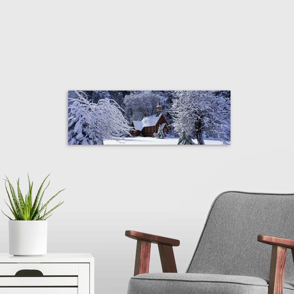 A modern room featuring Panoramic photo of a church in winter covered in snow at Yosemite National Park in California.