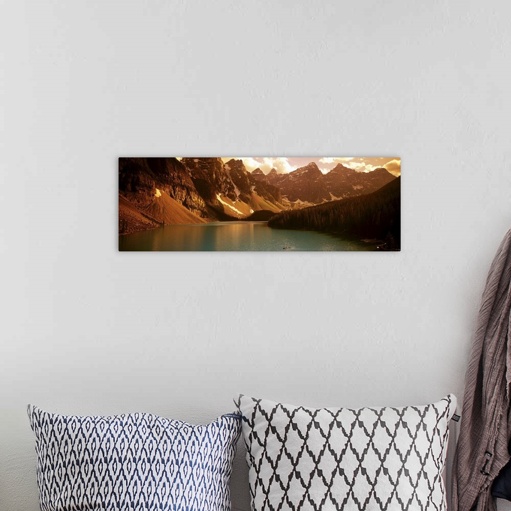 A bohemian room featuring Panoramic photograph of waterfront surrounded by mountains under a cloudy sky.