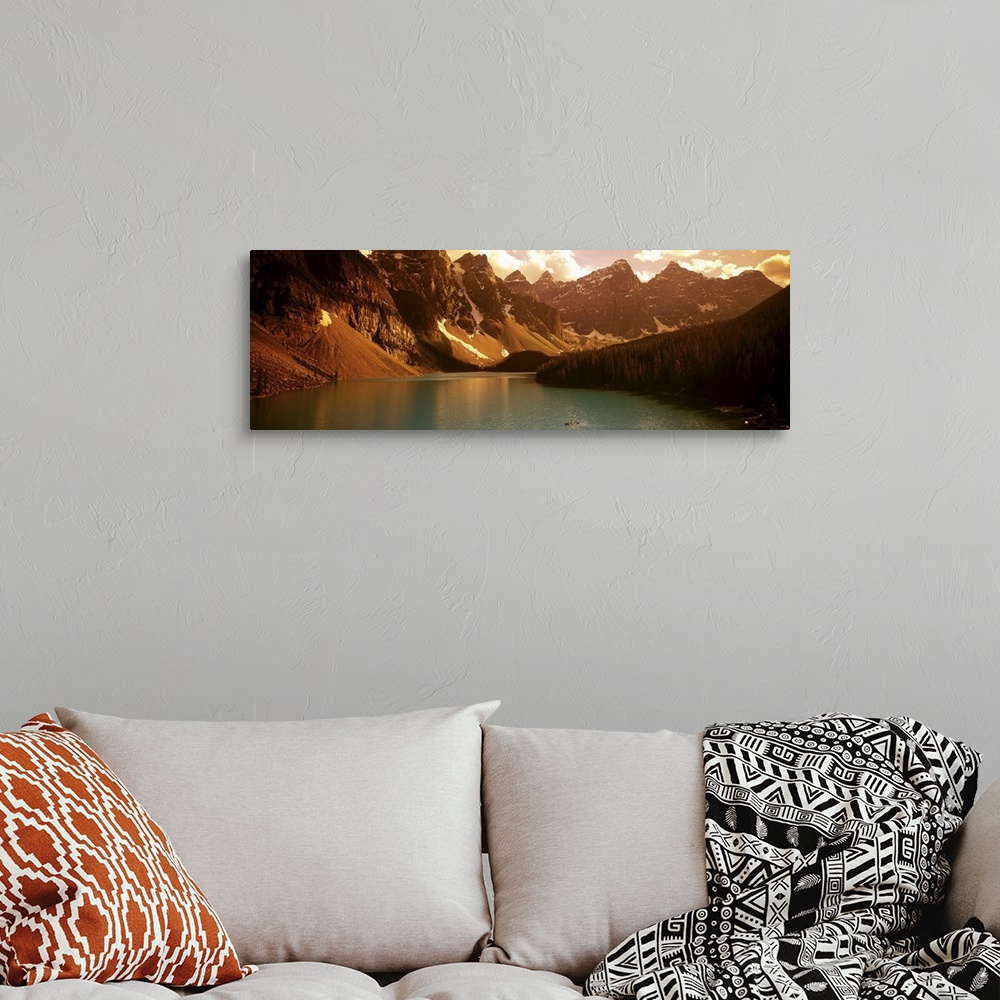 A bohemian room featuring Panoramic photograph of waterfront surrounded by mountains under a cloudy sky.