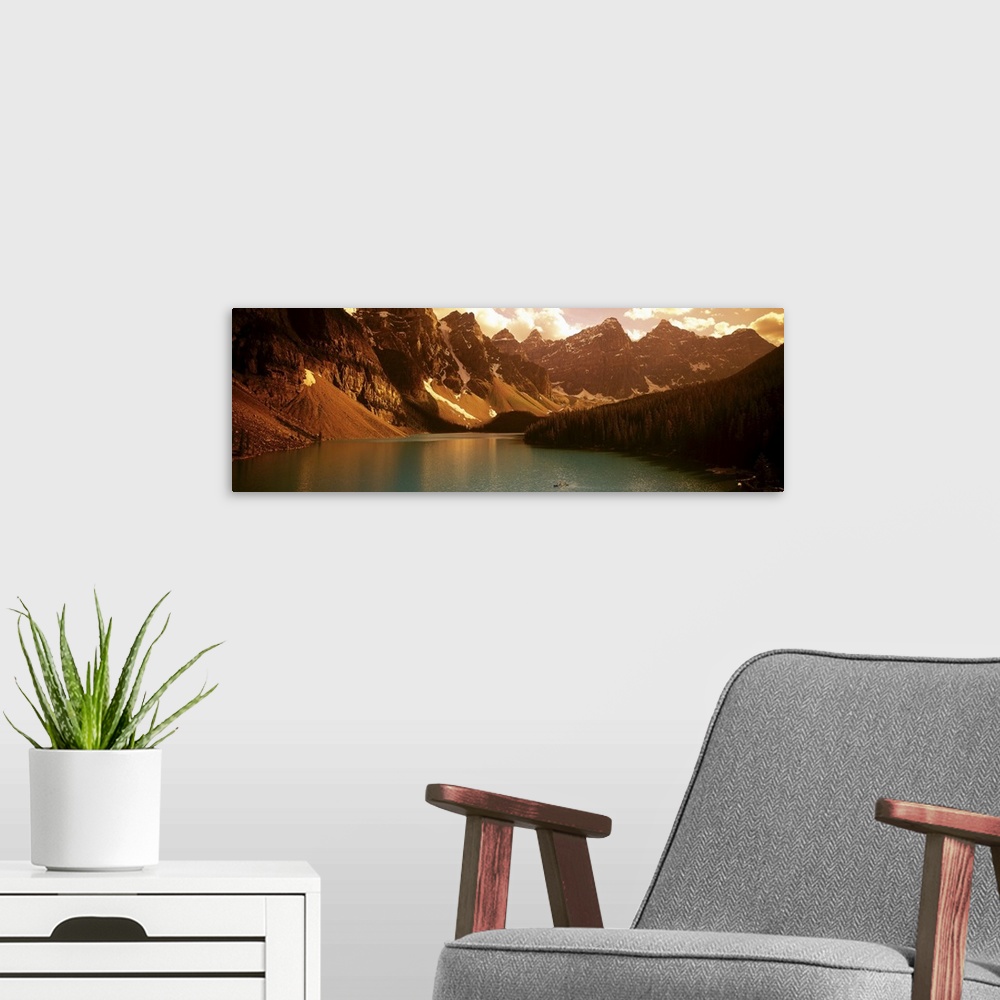 A modern room featuring Panoramic photograph of waterfront surrounded by mountains under a cloudy sky.