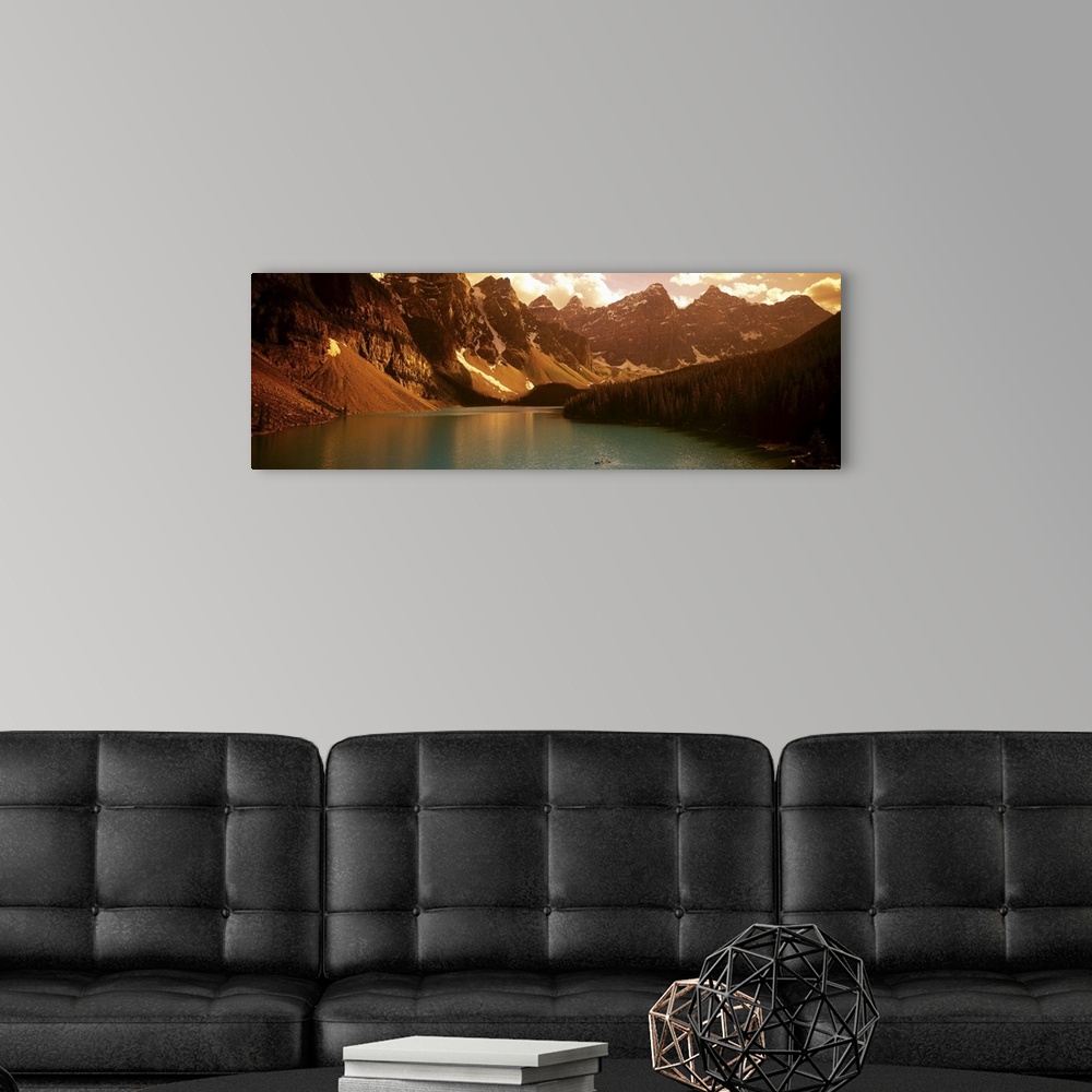A modern room featuring Panoramic photograph of waterfront surrounded by mountains under a cloudy sky.