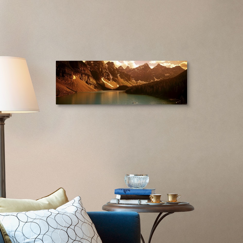 A traditional room featuring Panoramic photograph of waterfront surrounded by mountains under a cloudy sky.