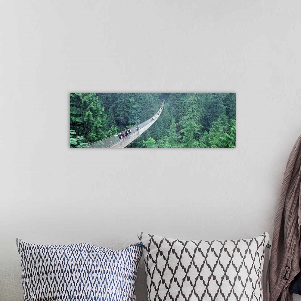 A bohemian room featuring Long horizontal photo on canvas of people walking across a long bridge that runs through the top ...