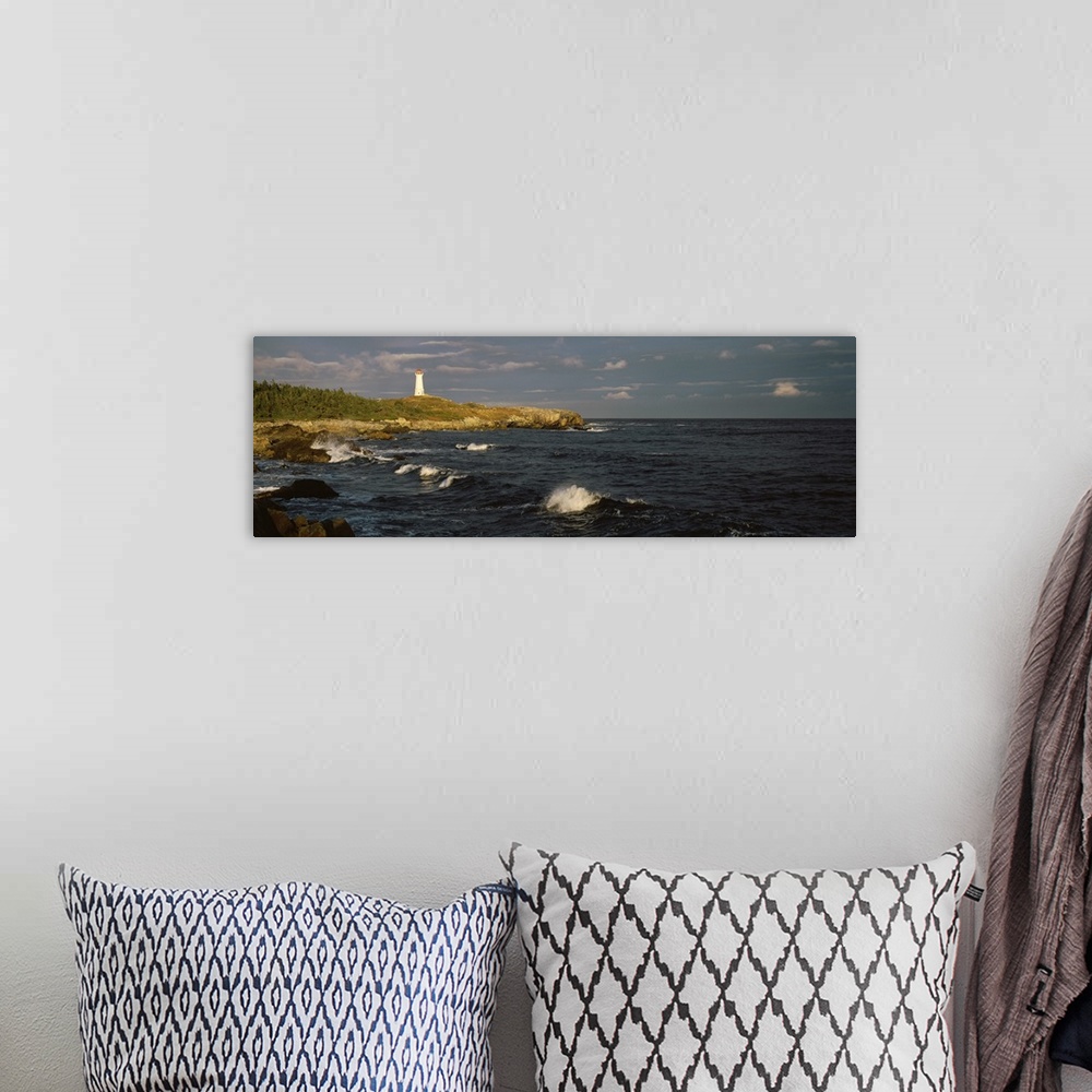 A bohemian room featuring Canada, Nova Scotia, Cape Breton Island, Louisburg lighthouse during sunset