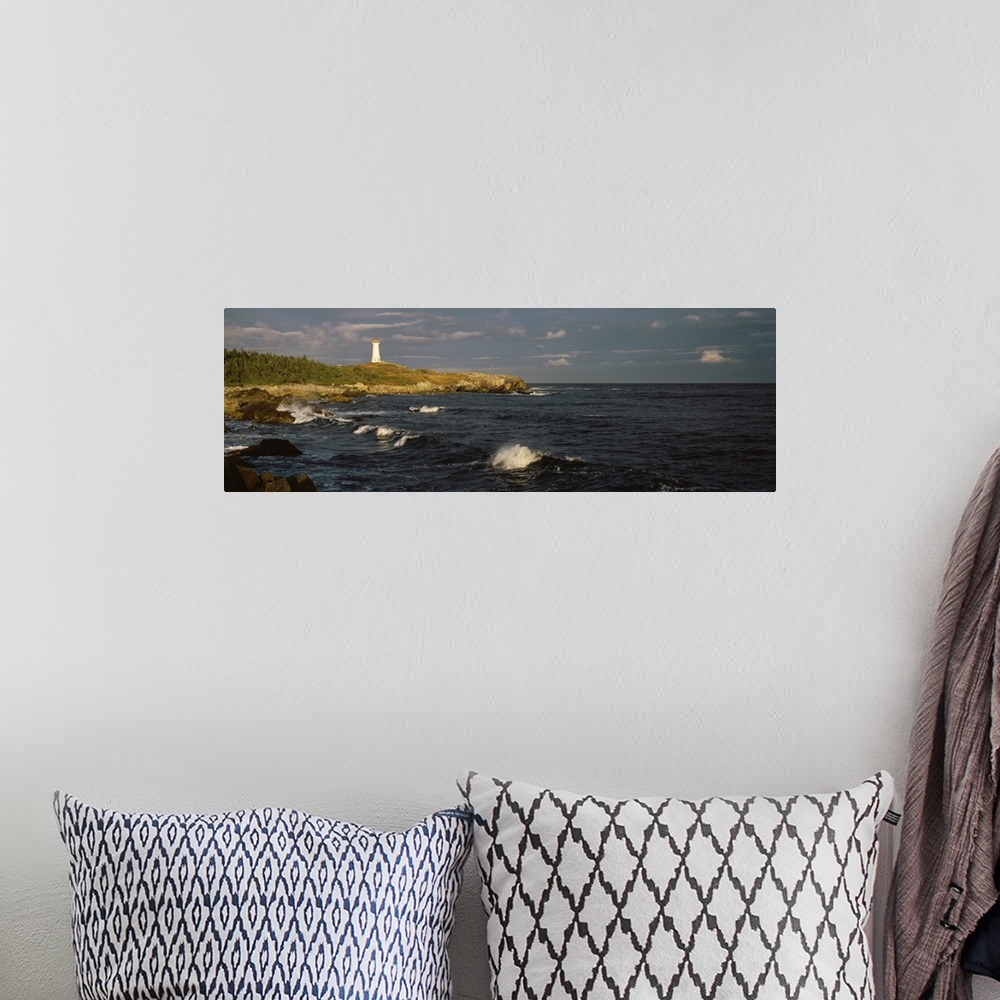 A bohemian room featuring Canada, Nova Scotia, Cape Breton Island, Louisburg lighthouse during sunset