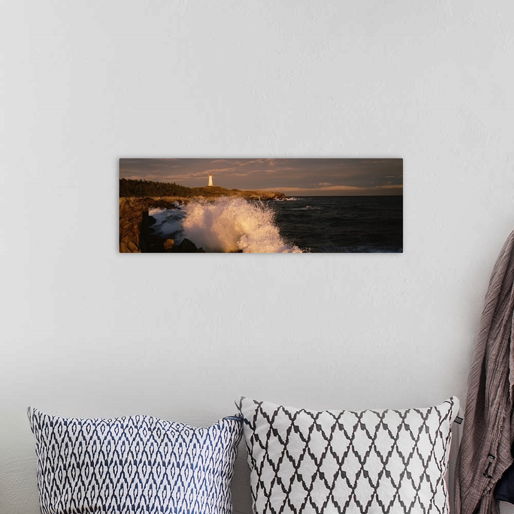 A bohemian room featuring Canada, Nova Scotia, Cape Breton Island, Waves breaking on the rocks near Louisbourg lighthouse
