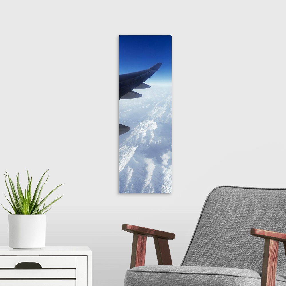 A modern room featuring Canadian Rockies from Airplane Window