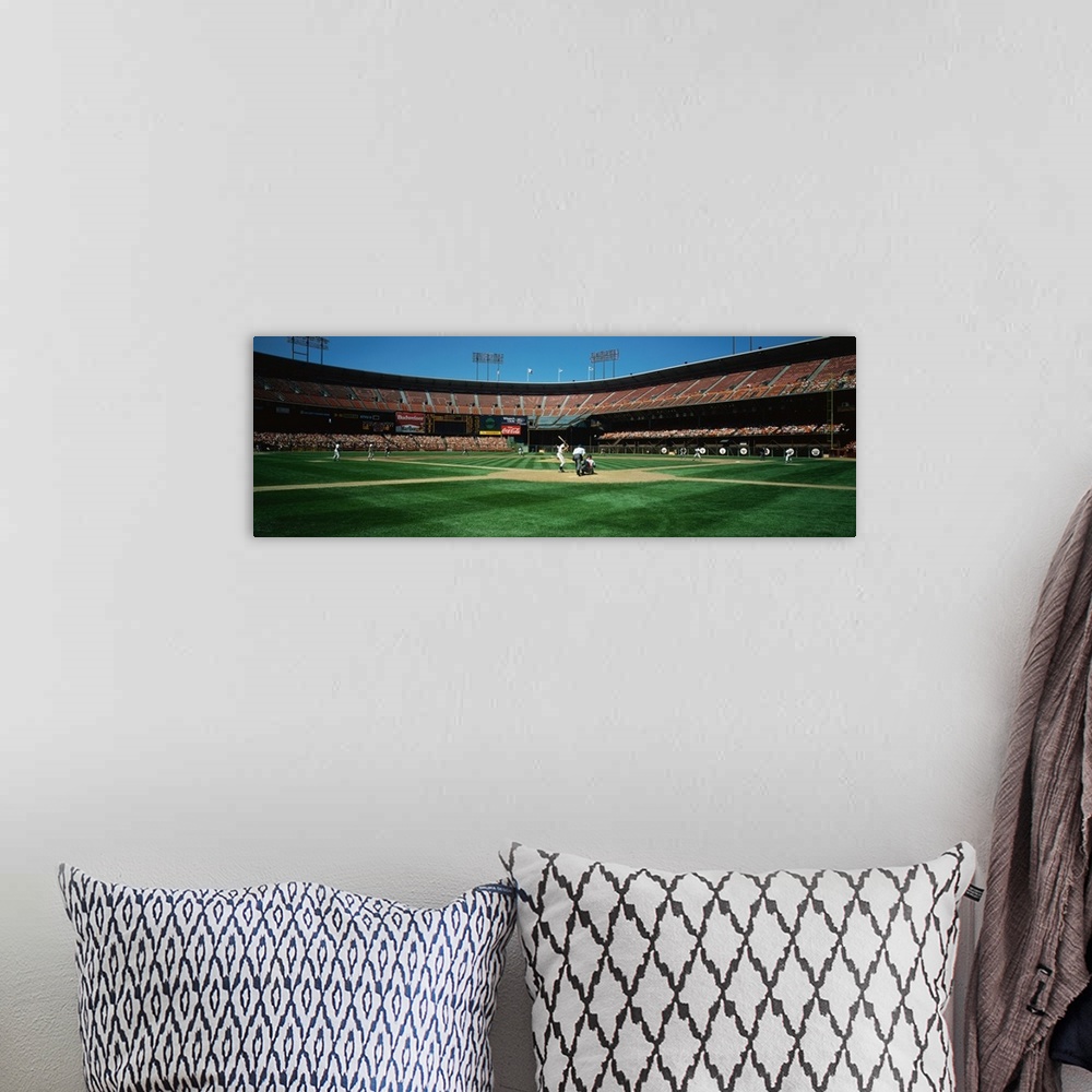 A bohemian room featuring Panoramic image on canvas of a baseball stadium as seen from the field behind the batter.