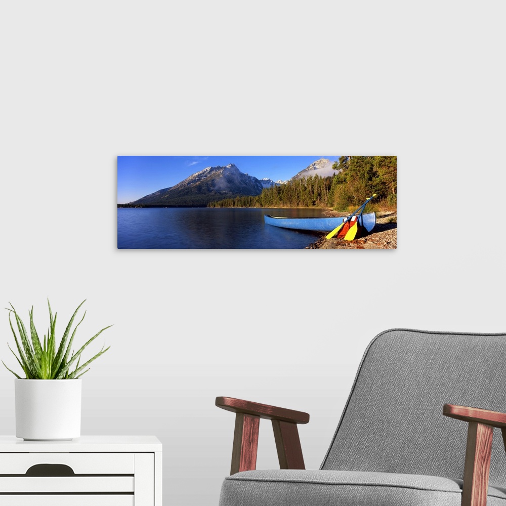 A modern room featuring Canoe in lake in front of mountains, Leigh Lake, Rockchuck Peak, Teton Range, Grand Teton Nationa...