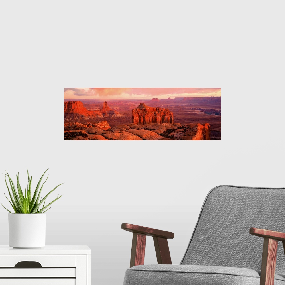 A modern room featuring Giant panoramic photo of the Canyonlands National Park in Utah (UT) with peaks and valleys as far...