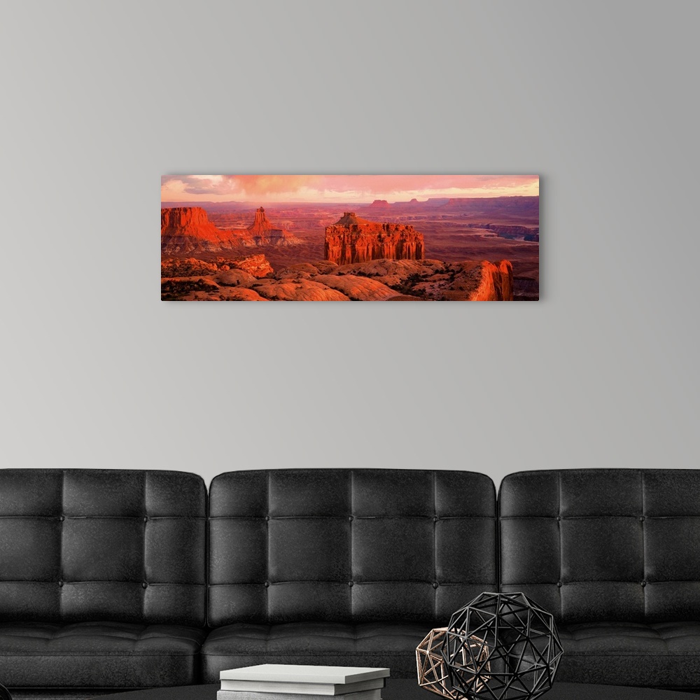 A modern room featuring Giant panoramic photo of the Canyonlands National Park in Utah (UT) with peaks and valleys as far...