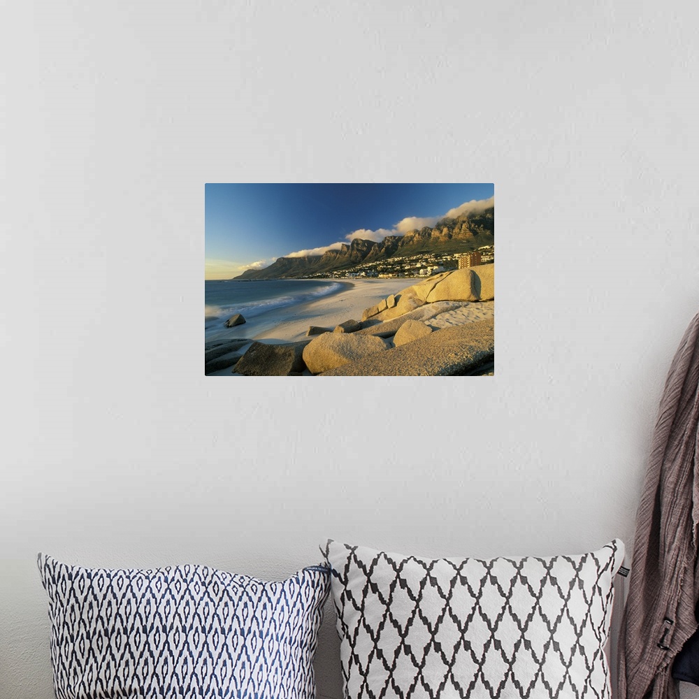 A bohemian room featuring Horizontal, large photograph of rocks on a beach in front of Cape town, South Africa and mountain...