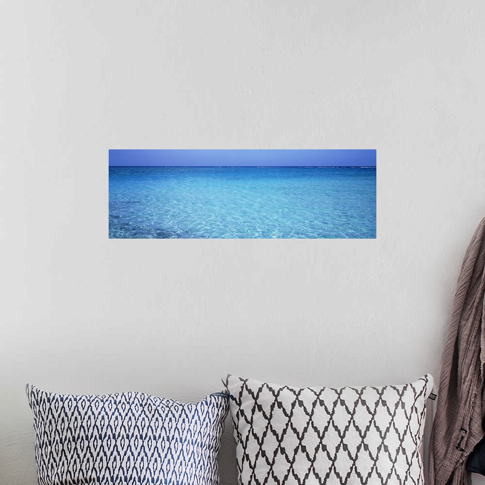 A bohemian room featuring Long panoramic photo print of crystal clear ocean water in the Caribbean.