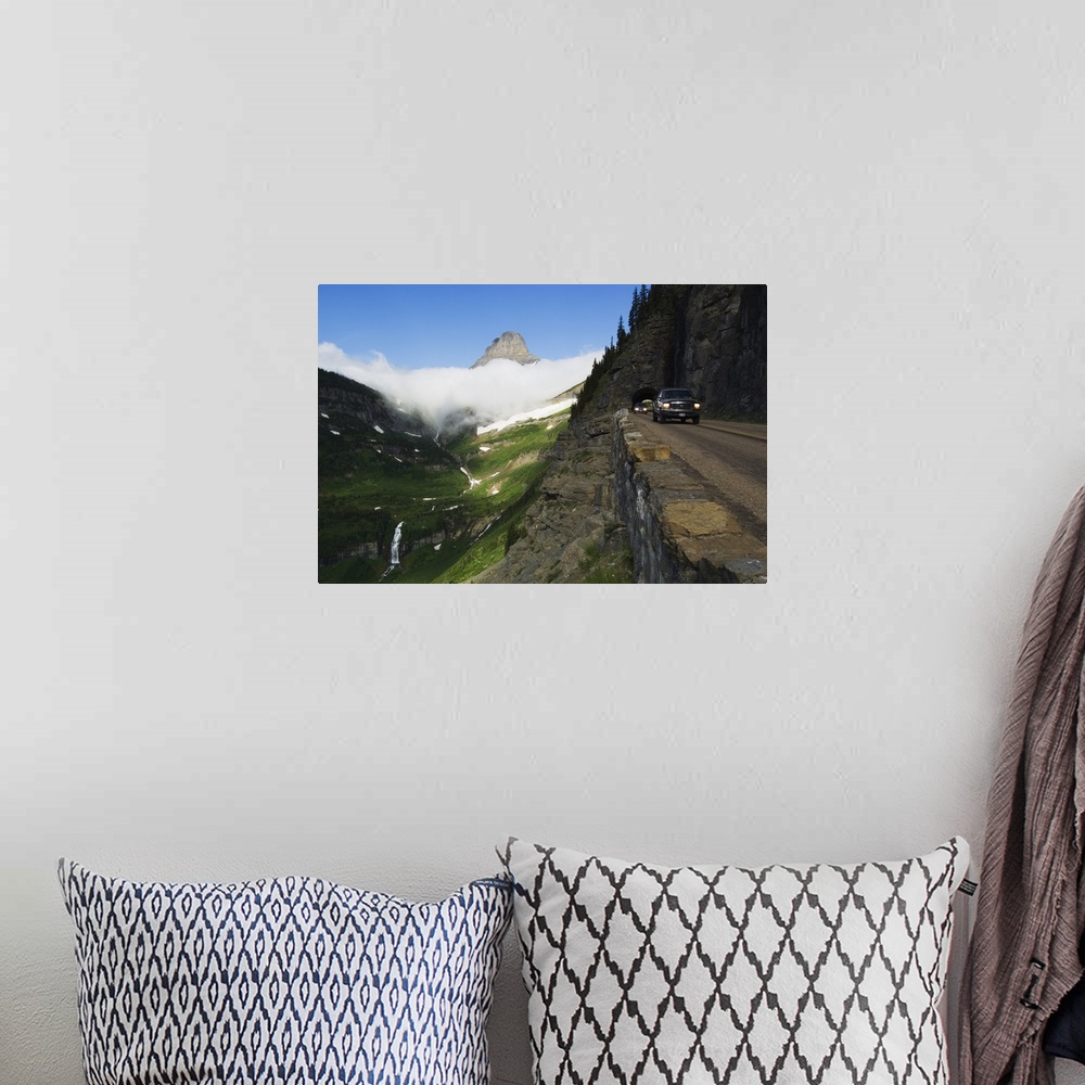 A bohemian room featuring Cars on Going to the Sun Road through mountainside tunnel, low clouds in valley, Glacier National...