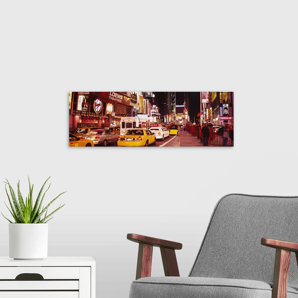 A modern room featuring Panoramic photograph of many cars and taxis filling the street in Times Square, surrounded by the...