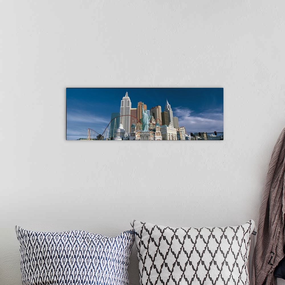 A bohemian room featuring This large panoramic photograph is of a casino in Las Vegas with a roller coaster and a scaled do...