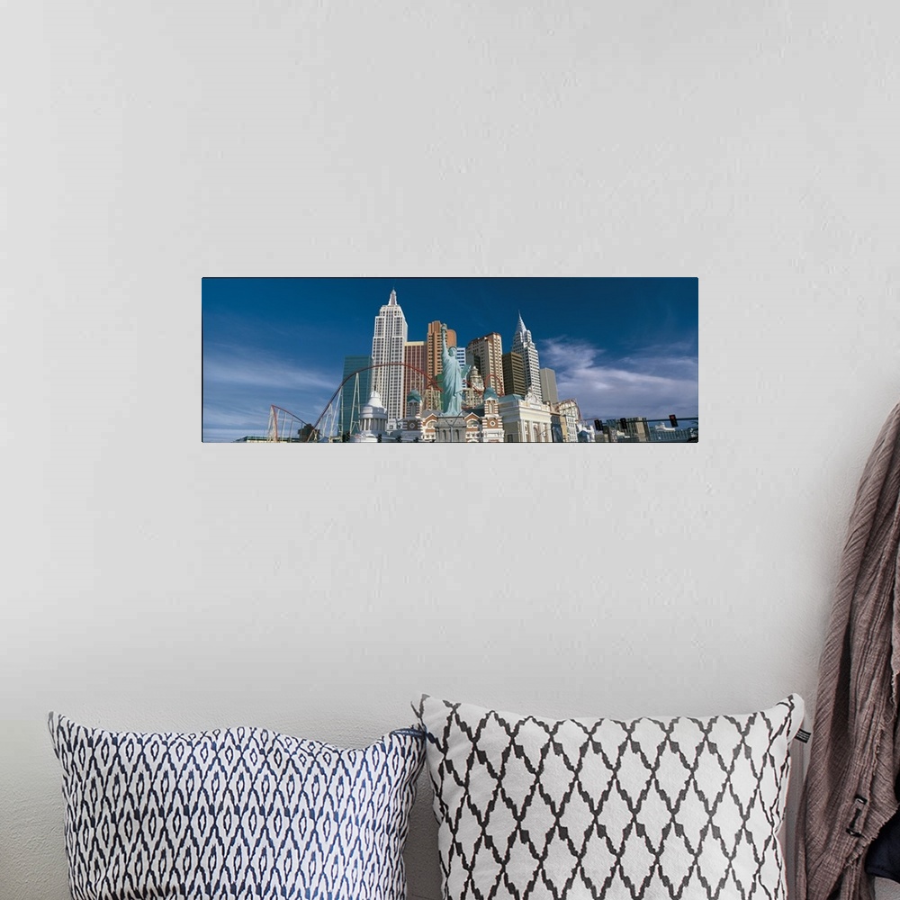 A bohemian room featuring This large panoramic photograph is of a casino in Las Vegas with a roller coaster and a scaled do...