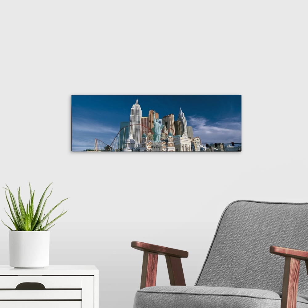 A modern room featuring This large panoramic photograph is of a casino in Las Vegas with a roller coaster and a scaled do...