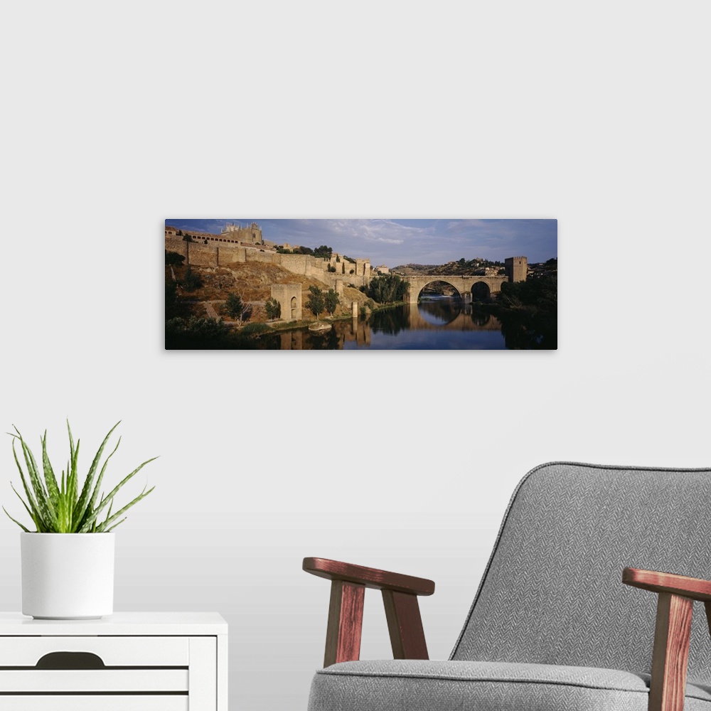 A modern room featuring Castle at the waterfront, Puente de San Martin, Tajo River, Toledo, Spain
