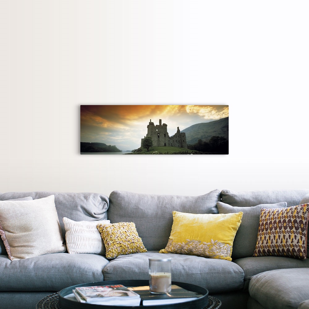 A farmhouse room featuring Panoramic photograph of stone palace on hillside at sunset.  There is water in the distance and t...