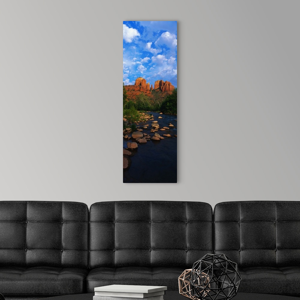 A modern room featuring Giant, vertical photograph of a rocky river in Oak Creek Red Rock Crossing, in Arizona, leading t...