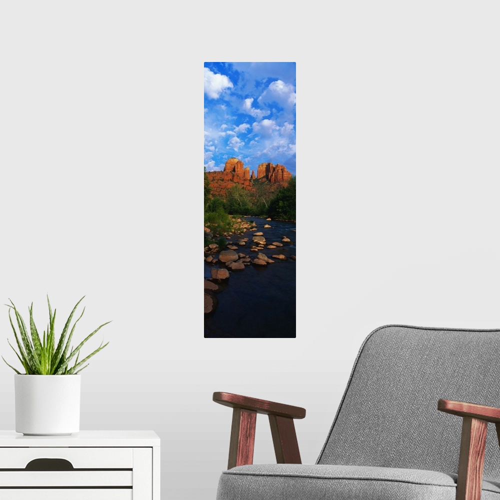 A modern room featuring Giant, vertical photograph of a rocky river in Oak Creek Red Rock Crossing, in Arizona, leading t...